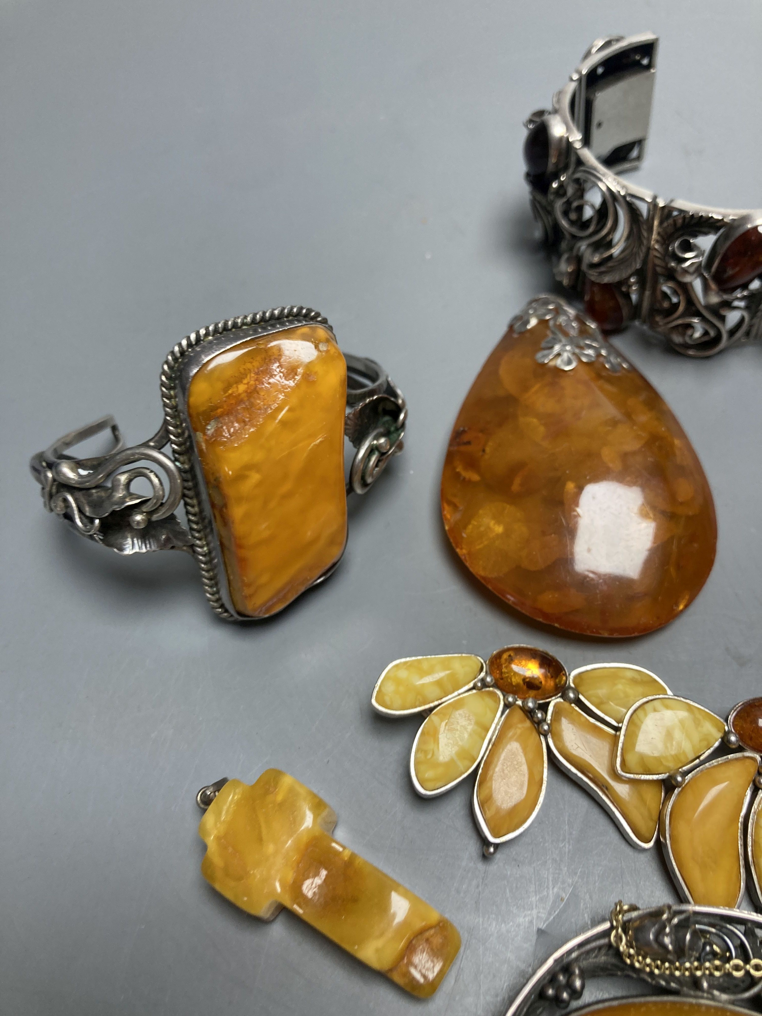 A mixed group of amber jewellery including white metal mounted bangle and Portuguese 925 bracelet.